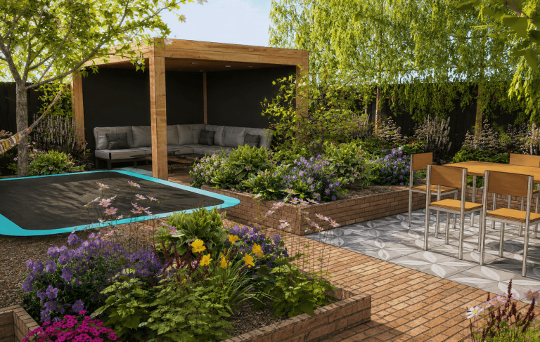 Tuin met een trampoline, zitgedeelte en bloeiende planten in een zonnige omgeving.